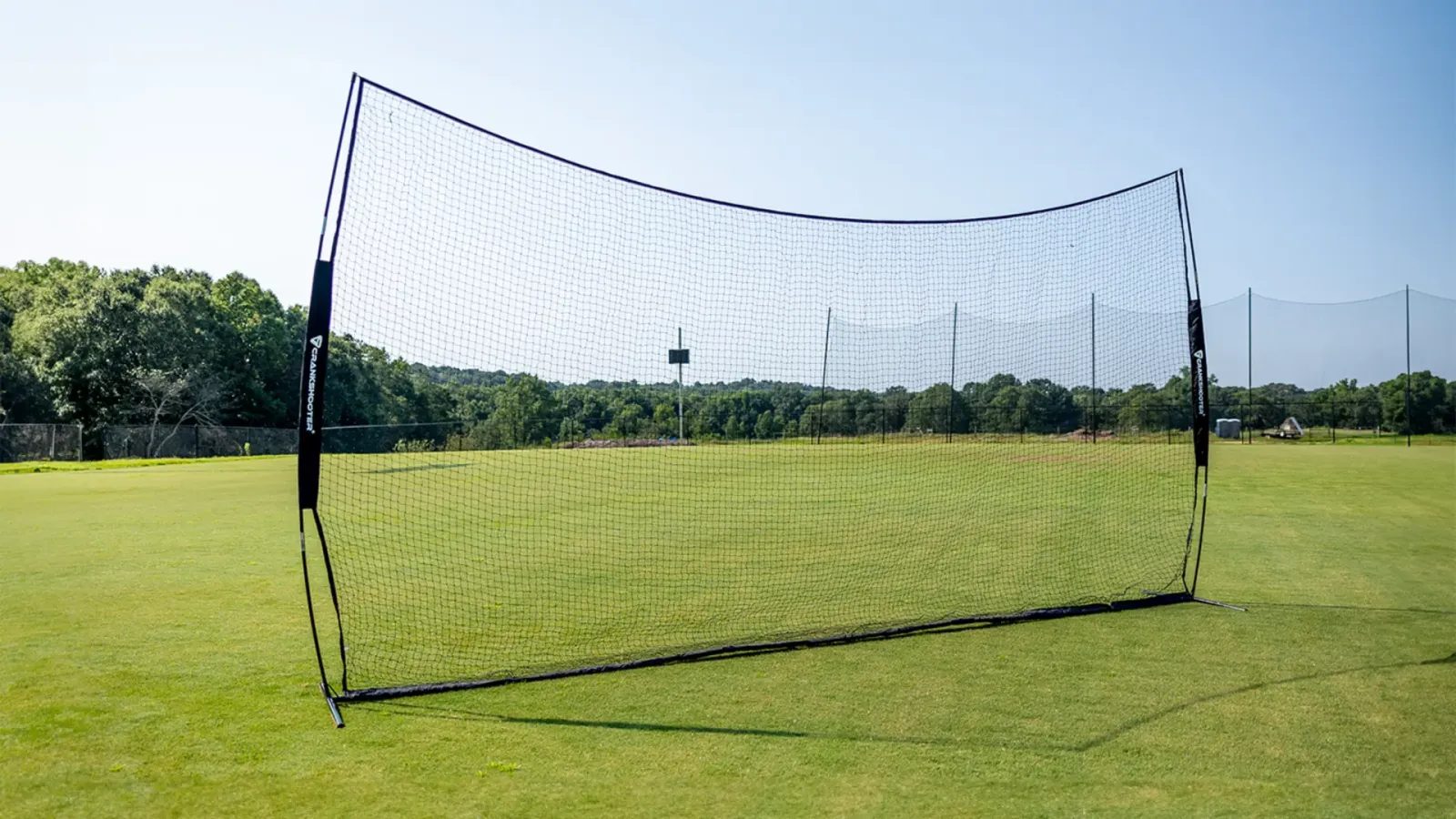 Crankshooter backstop net set up on a grass practice field