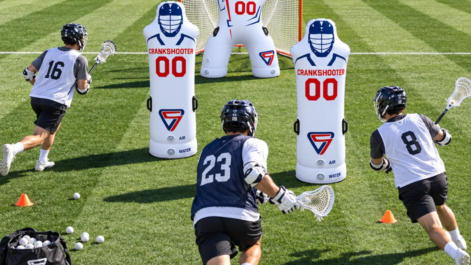 Inflatable lacrosse goalie in the cage with two inflatable defenders and players in pinnies on turf